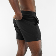 Stretch Swim 5.5" in Black side on model zipping back right zippered pocket