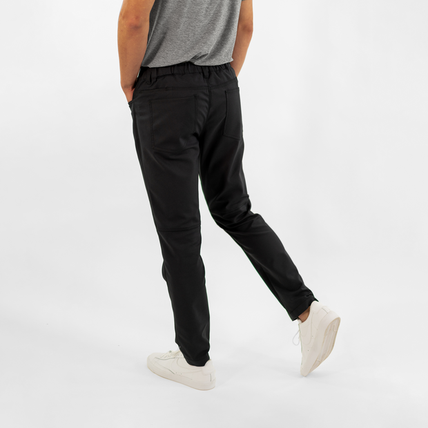 Ace Pant Black back on model with two patch pockets with Quickdraw™ pockets above them for phone storage