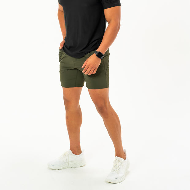 Atlas Short 7" Military Green on Model Full Body worn with Short Sleeve Tech Tee in Solid Black