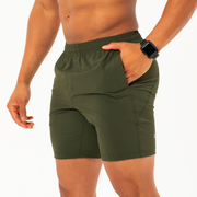 Atlas Short 7" Military Green on Model front left side angle with hand in inseam pocket