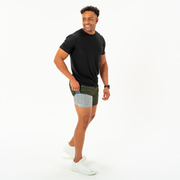 Base Short 7" Military Green showing grey heather liner that has a built-in phone pocket on model with a Black Short Sleeve Tech Tee