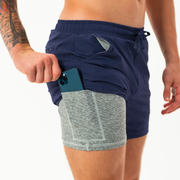 Base Short 5.5" Navy on model showing grey heather liner that has a built-in phone pocket