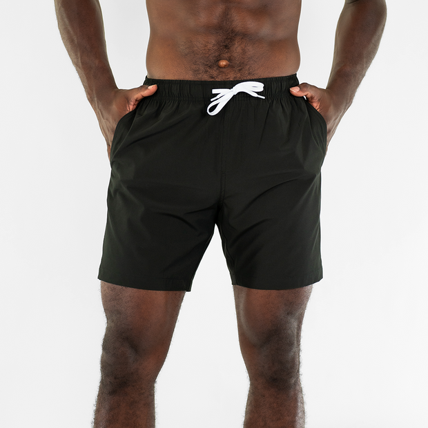Stretch Swim 7" in Black front on model with hands in inseam pockets