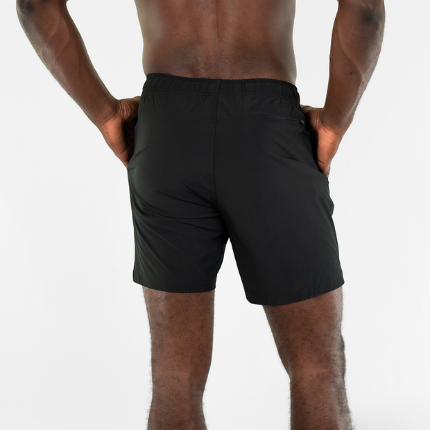 Stretch Swim 7" in Black back on model with hands in inseam pockets