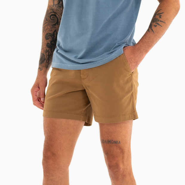 Stretch Short 5.5" Camel side on model with zipper fly and two inseam pockets worn with Natural Dye Logo Tee Ocean