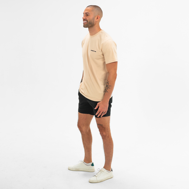 Stretch Chino Short 5.5" in Black on model worn with Natural Dye Logo Tee in Sand