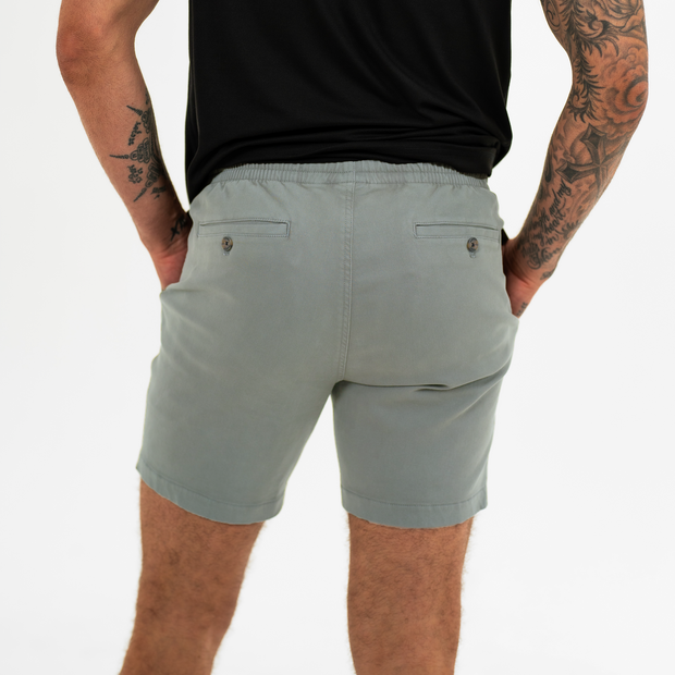Alto Short 7" inseam in Grey back on model with elastic waistband and two welt pocket with horn buttons