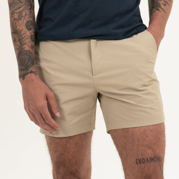 Tour Short 5.5" Khaki on model with flat elastic waistband, belt loops, snap-button, zipper fly, and two front seam pockets