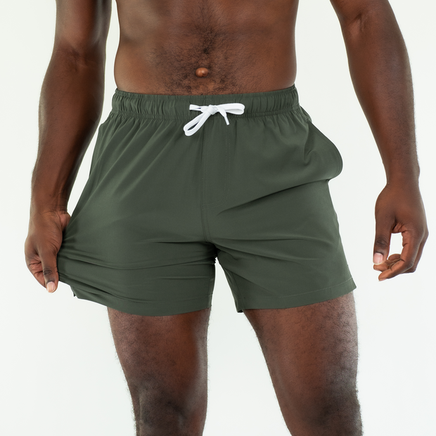 Stretch Swim 5.5" in Military Green front on model stretching leg fabric