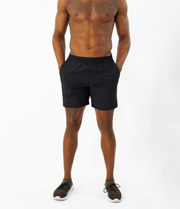 Atlas Short 7" Black on model front with hands in inseam pockets