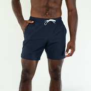 Stretch Swim 7" in Navy front on model with hand in inseam pocket