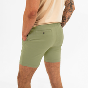 Alto Short 7" inseam in Olive back left side on model with elastic waistband and two welt pocket with horn buttons