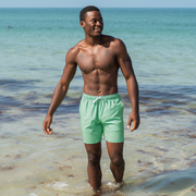 Stretch Swim 7" Seafoam front on model walking in water on the beach