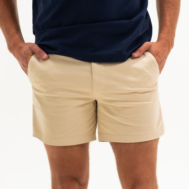 Stretch Short 5.5" Sand Dune front on model with zipper fly and two inseam pockets worn with Short Sleeve Stretch Henley Navy