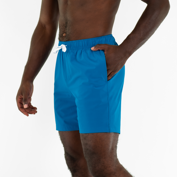 Stretch Swim 7" Blue side on model with hand in inseam pocket
