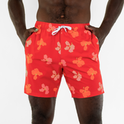 Stretch Swim 7" Hibiscus front, on model with both hands in inseam pockets