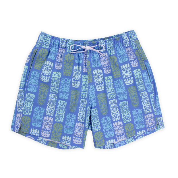 Stretch Swim 5.5" Tiki Tiki Front with blue background and light blue, white, light pink, and light green tiki faces printed in a line pattern with an elastic waistband, two inseam pockets, and a white drawstring