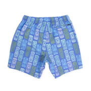 Stretch Swim 7" Tiki Tiki back with blue background and light blue, white, light pink, and light green tiki faces printed in a line pattern with an elastic waistband and back right zippered pocket