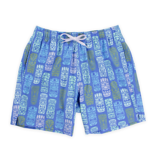 Stretch Swim 7" Tiki Tiki Front with blue background and light blue, white, light pink, and light green tiki faces printed in a line pattern with an elastic waistband, two inseam pockets, and a white drawstring
