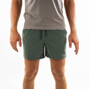 Volley Short 5.5" Green on model with elastic waistband and black and white drawstring