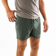 Volley Short 5.5" Green on model photo 2 with elastic waistband and black and white drawstring