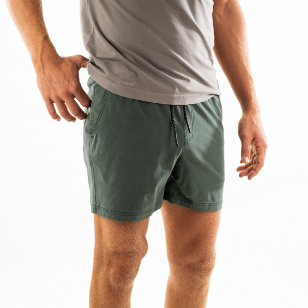 Volley Short 5.5" Green on model photo 2 with elastic waistband and black and white drawstring