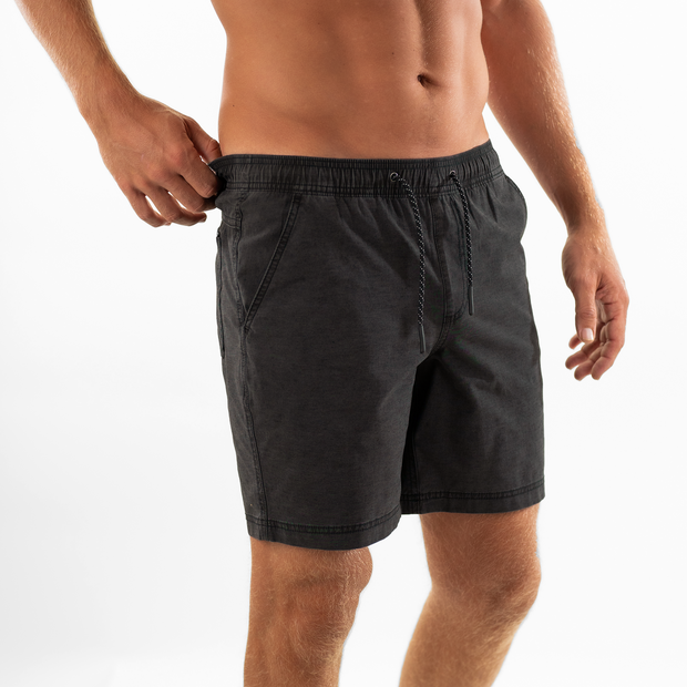 Volley Short 7" Black side on model with elastic waistband and black and white drawstring