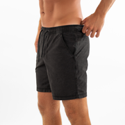 Volley Short 7" Black left side on model with elastic waistband and black and white drawstring