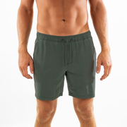 Volley Short 7" Green Front on model with elastic waistband and black and white drawstring